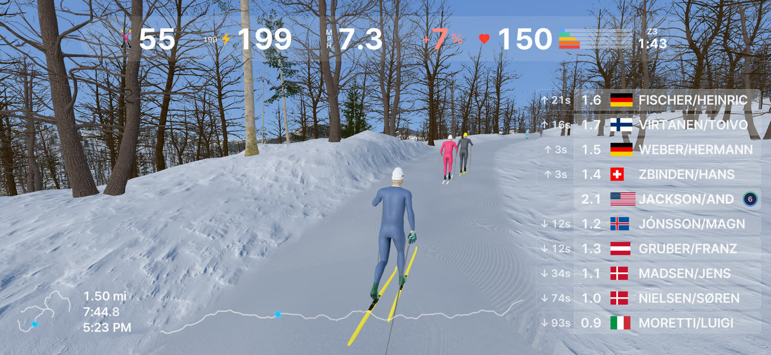 A skier on a quiet groomed trail with two others up ahead