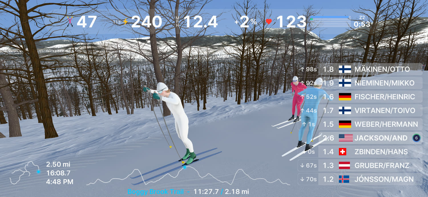 A groomed trail running out toward snow covered hills, a segment time on screen